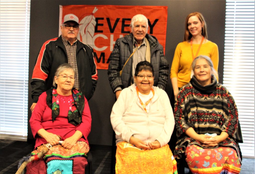 Image of four Elders Council members, Knowledge Keeper and Acting Advocate.